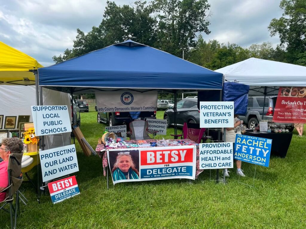 Tent in a green setting with political signs