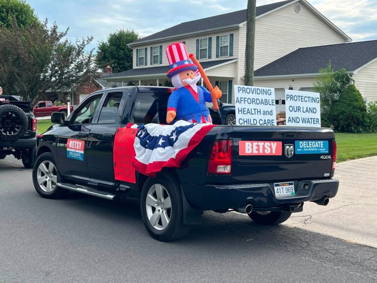 Blue pickup truck with colorful campaign information and decoration